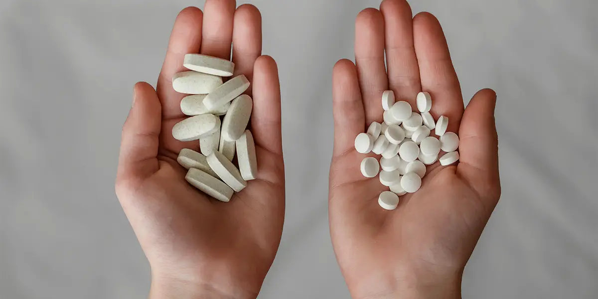 Hands holding finasteride and minoxidil for hair loss treatment.