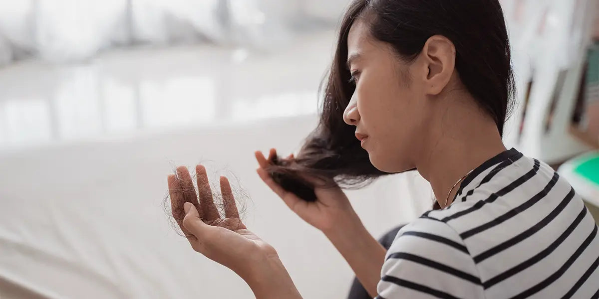 Middle aged woman showing causes of hair loss in women.