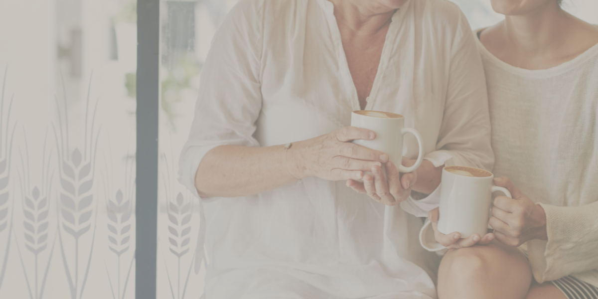 Mother and daughter sitting next to each other talking about hair loss.
