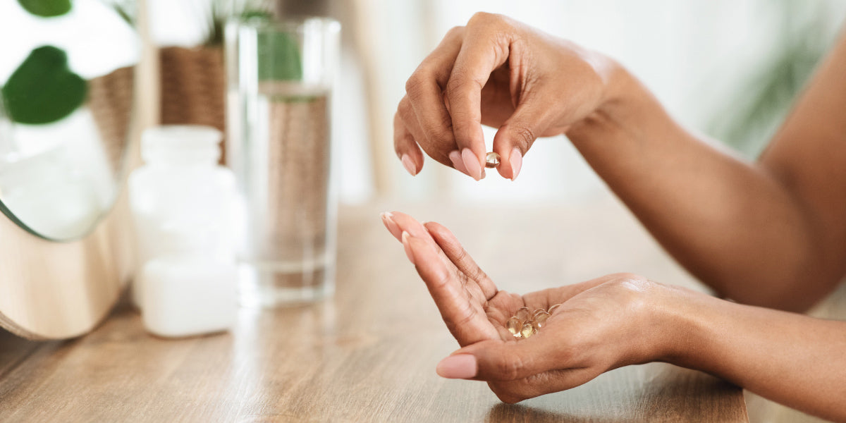 Image of woman holding biotin hair loss supplement pills.