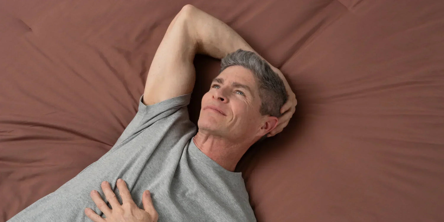 middle aged man laying back happy to not have erectile dysfunction while taking dutasteride