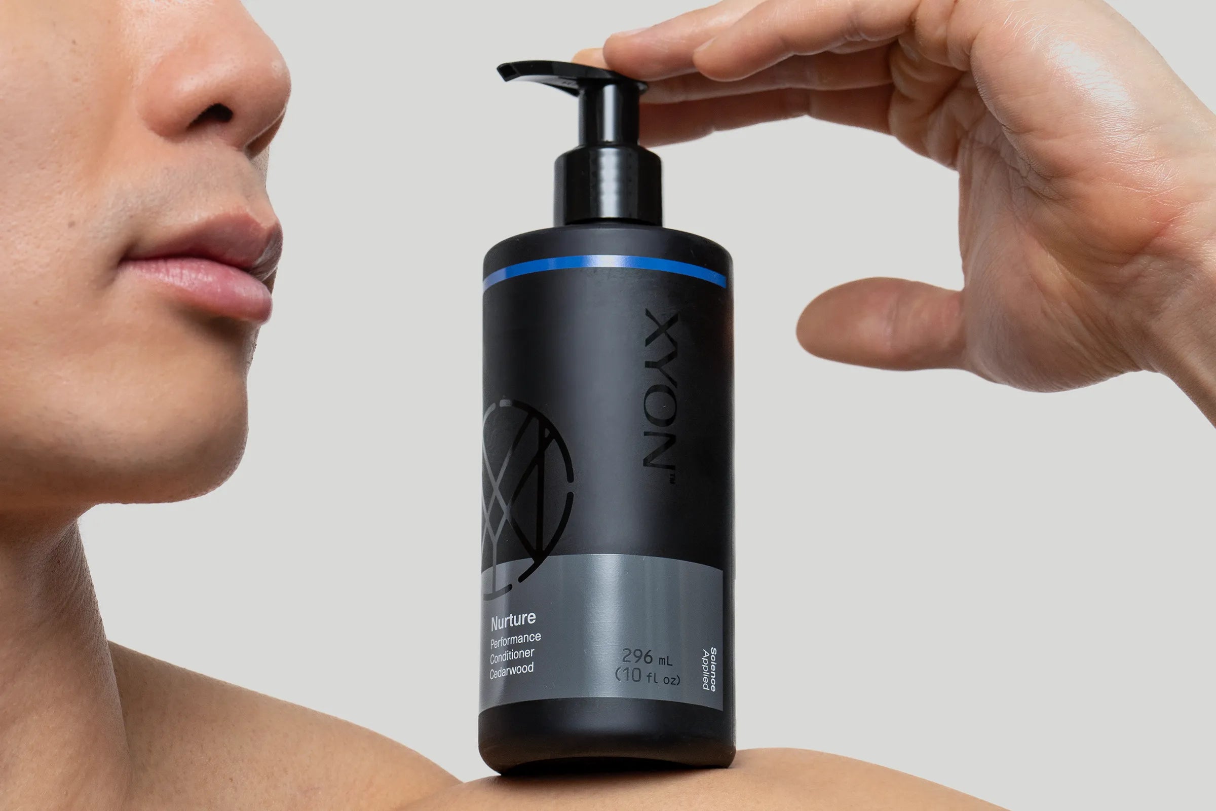 XYON men's shampoo on man's shoulder