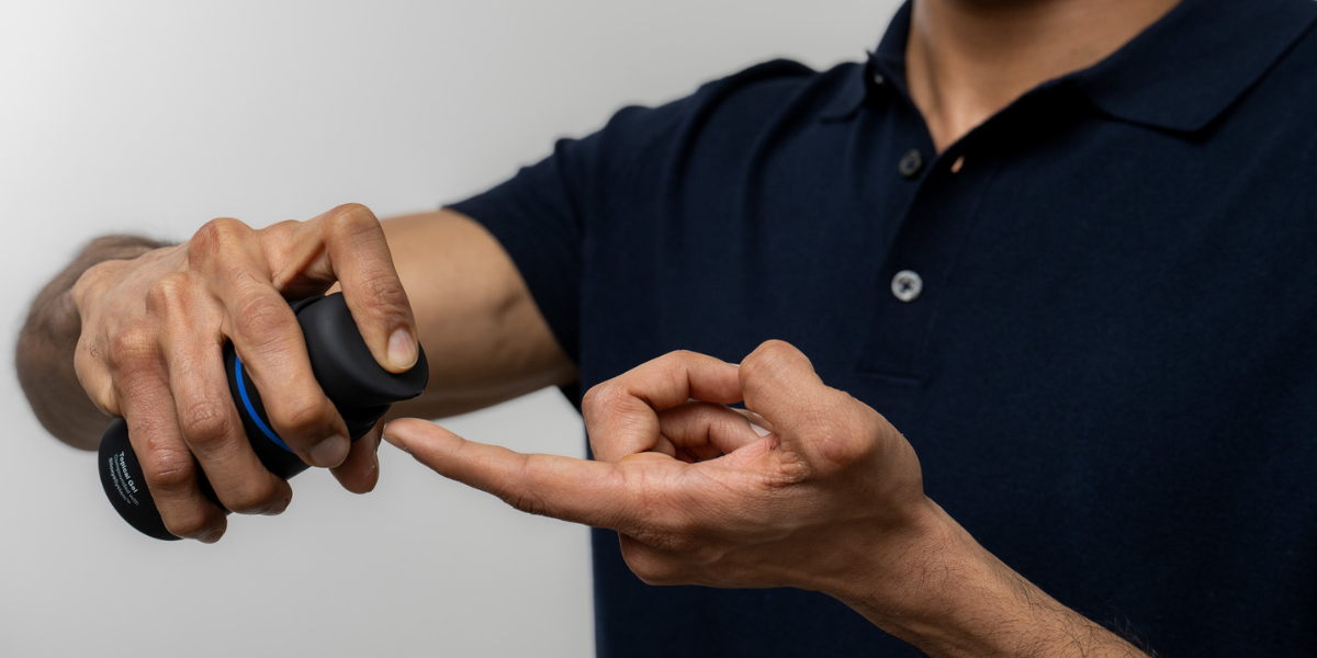 Image of person squeezing topical hair loss medication onto their finger.