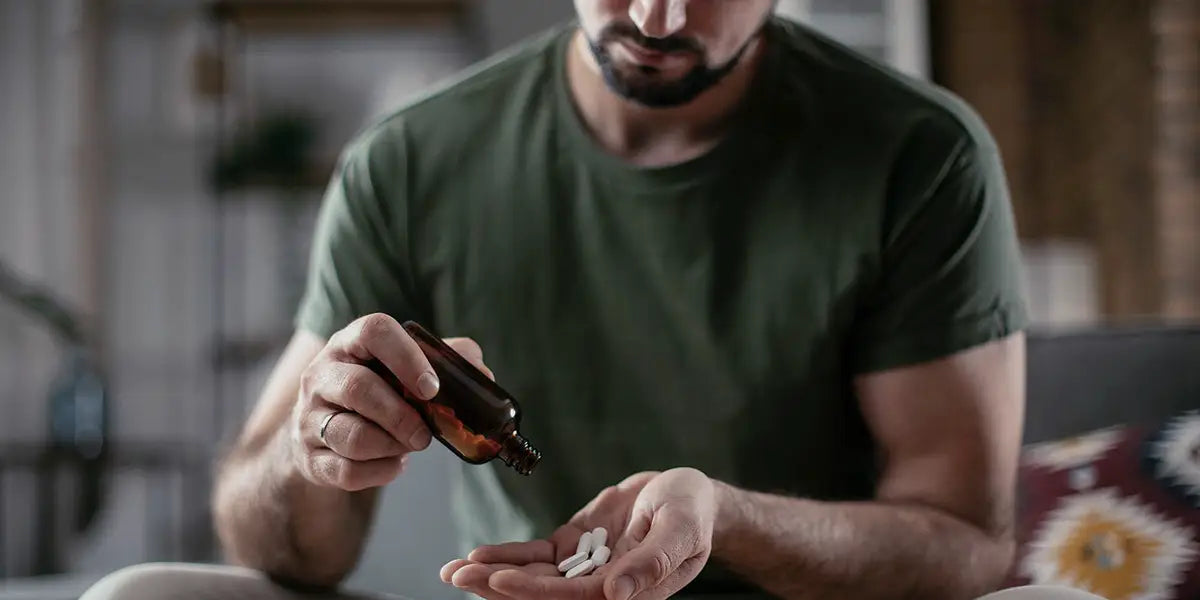 Man assessing tablets of finasteride 5mg in his hand.