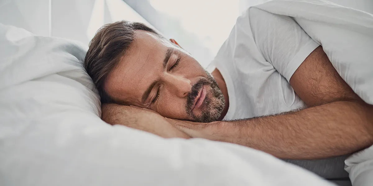 Middle aged man sleeping for hair loss prevention.