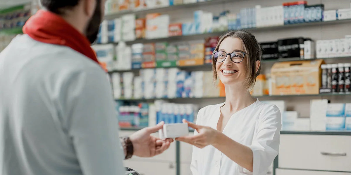 Pharmacist giving patient finasteride over the counter.