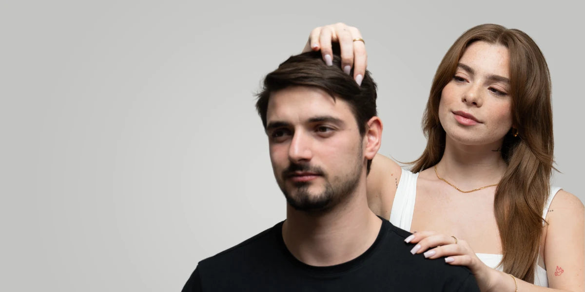 Young couple looking for signs of hair loss.