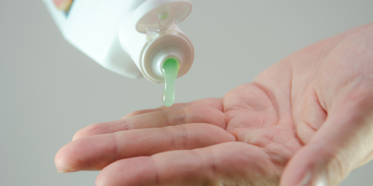 Ketoconazole shampoo being dispensed into open palm.