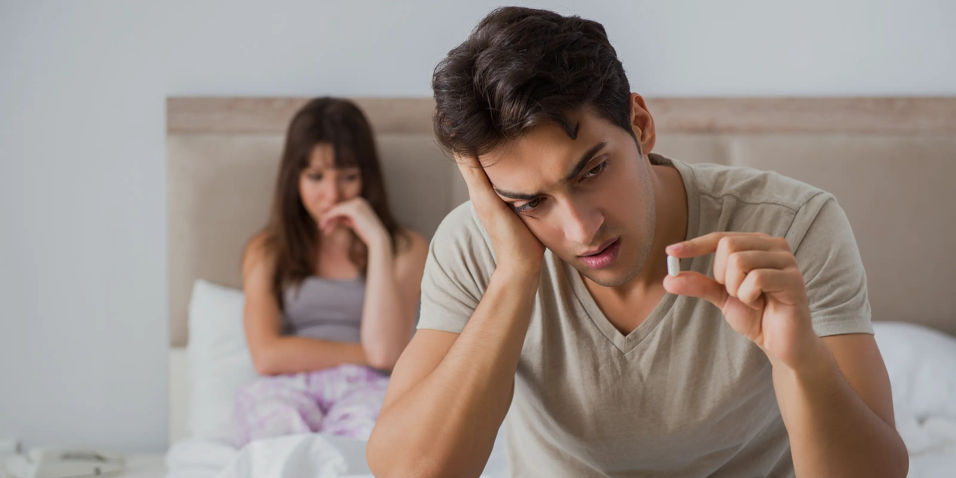 Young man looking at tablet thinking about finasteride side effects.