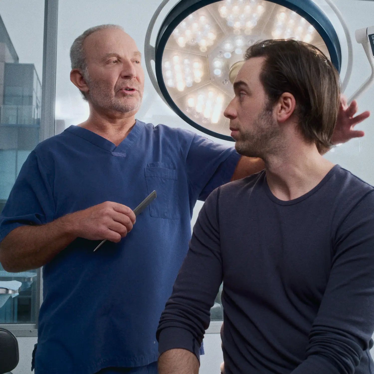 A doctor performing a hair loss consultation on a xyon customer