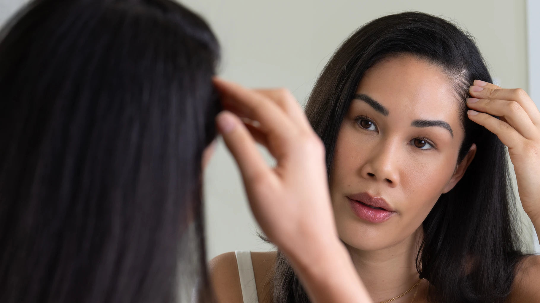 woman inspecting her hair